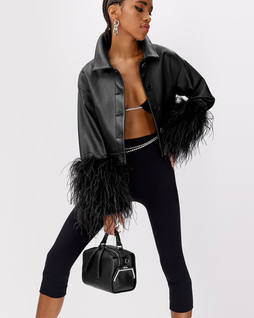 Model posed with Kimora Bag in black leather with leather handle brass clasp buckle