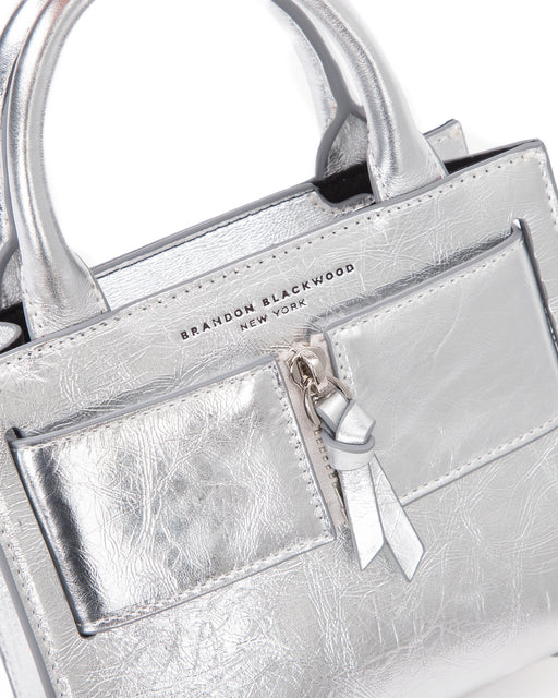 Angled close up of Kuei Bag in silver crinkle leather