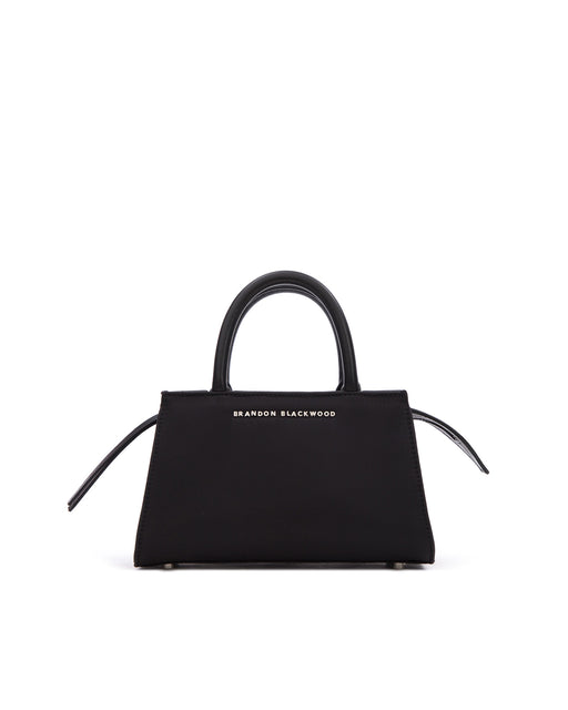 Front of Arlen Bag, black nylon body with leather handle, Brandon Blackwood hardware logo, exaggerated zipper detail