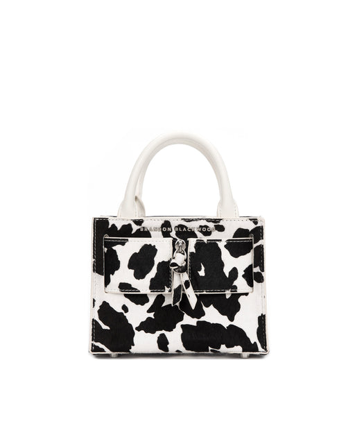 Front of Kuei Bag in black and white cow print ponyhair with ponyhair silver zipper 