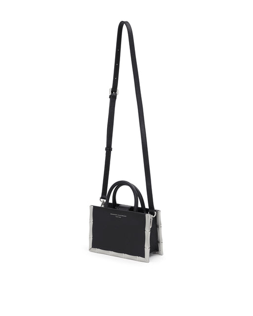 Bamboo B Tote, in black leather with leather handle and silver bamboo embossed trim, hanging from cross body strap