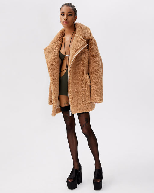 Model in The Hata in camel Faux camel teddy fur with convertible collar with Double Breasted Silver zipper closure