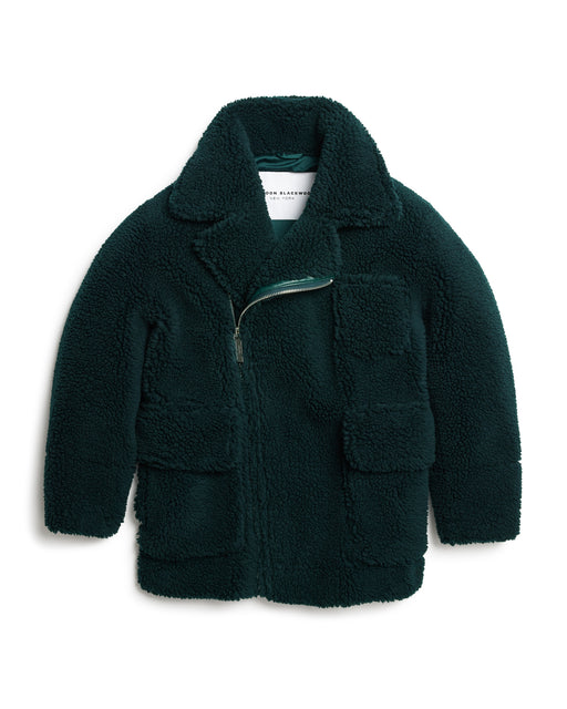 Front of The Hata in Forest Green Faux camel teddy fur with convertible collar, three-patch and inseam pockets. Double Breasted Silver zipper closure