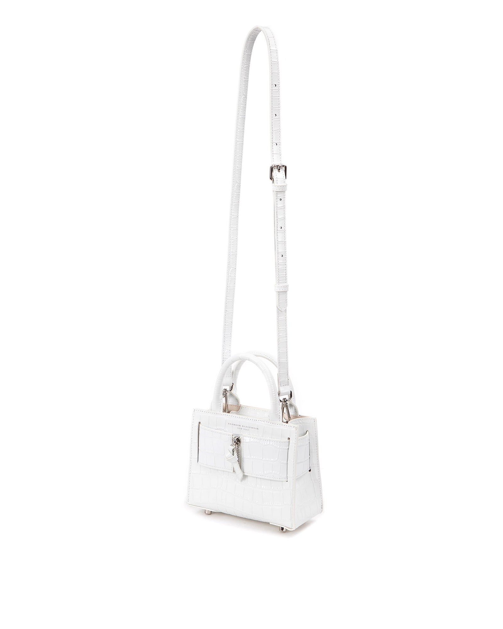 Angled over head view of wide open Kuei Bag in white croc embossed leather with white croc embossed handle white croc embossed silver zipper  hanging with strap