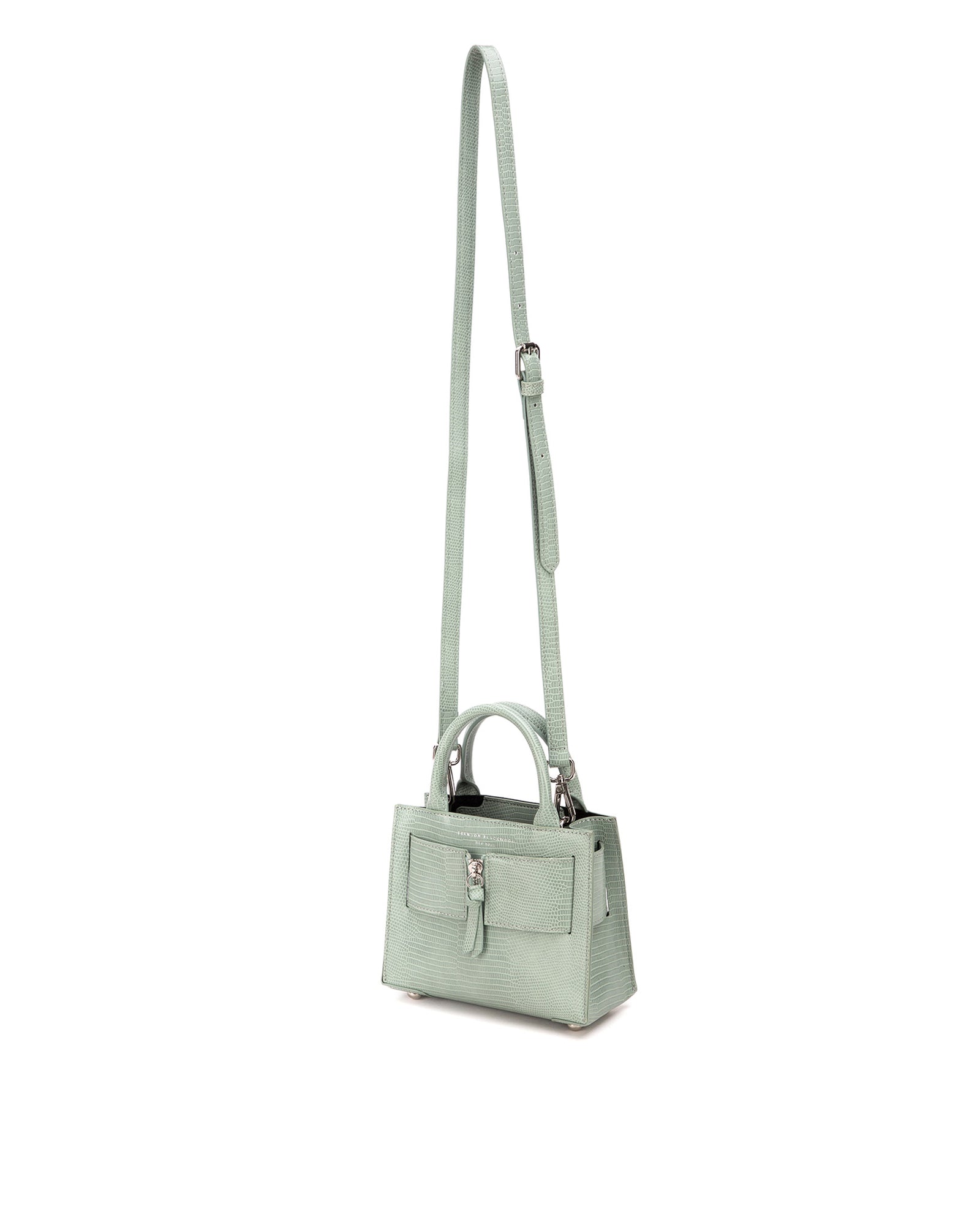 Angled over head view of wide open Kuei Bag in cream croc embossed with cream croc embossed handle cream croc embossed silver zipper hanging from strap