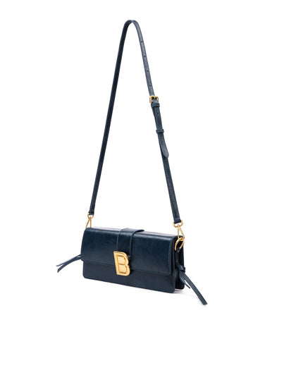  Nia Bag with navy cracked leather with brown cracked strap with brass logo magnetic closure hanging with strap thumbnail 9