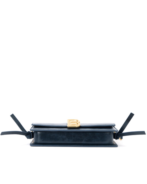 Bottom of Nia Bag with navy cracked leather four metal feet