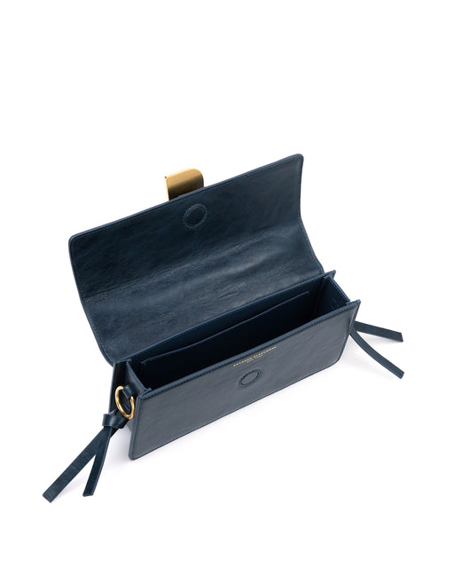 Angled over head view of wide open Nia Bag navy cracked leather and navy cracked leather strap with brass logo magnetic closure