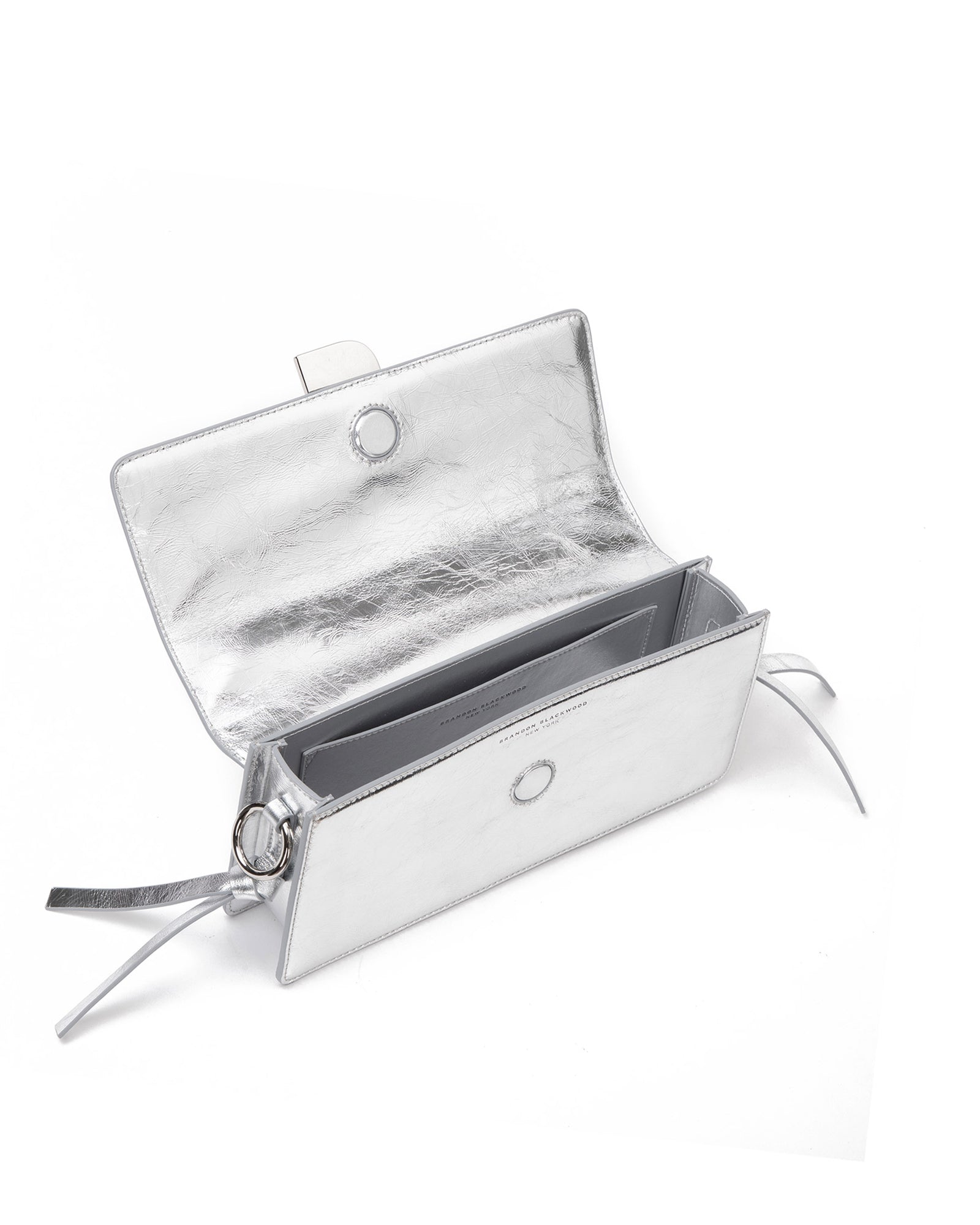 Angled over head view of wide open Nia Bag silver cracked leather and silver cracked leather strap with silver logo magnetic closure