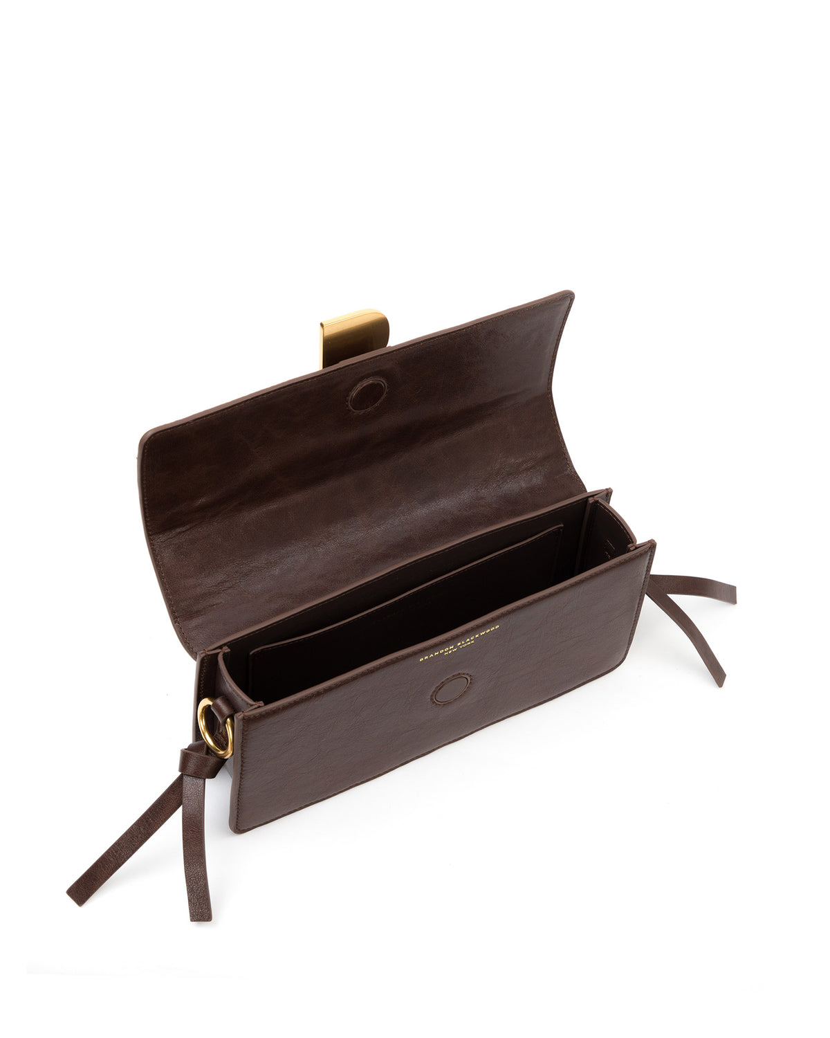 Angled over head view of wide open Nia Bag with open Nia Bag with brown cracked leather and brown cracked leather strap with brass logo magnetic closure
