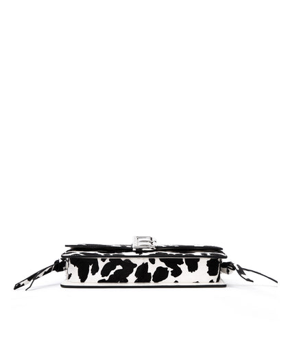 Bottom of Nia Bag with  black and white cow print four metal feet thumbnail 4