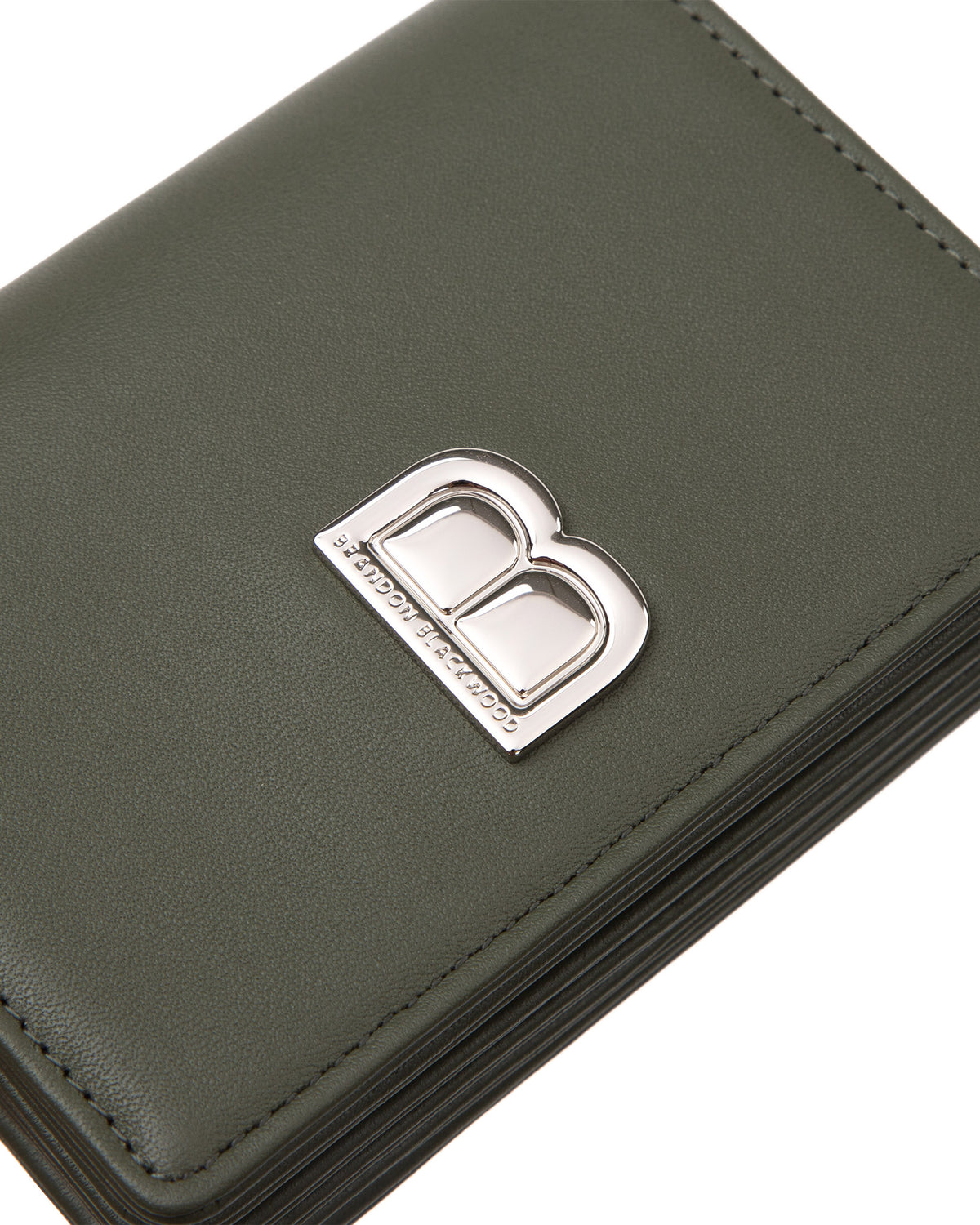 Angled close up of Accordion Card case, green leather body, silver Brandon Blackwood buckle, wristlet