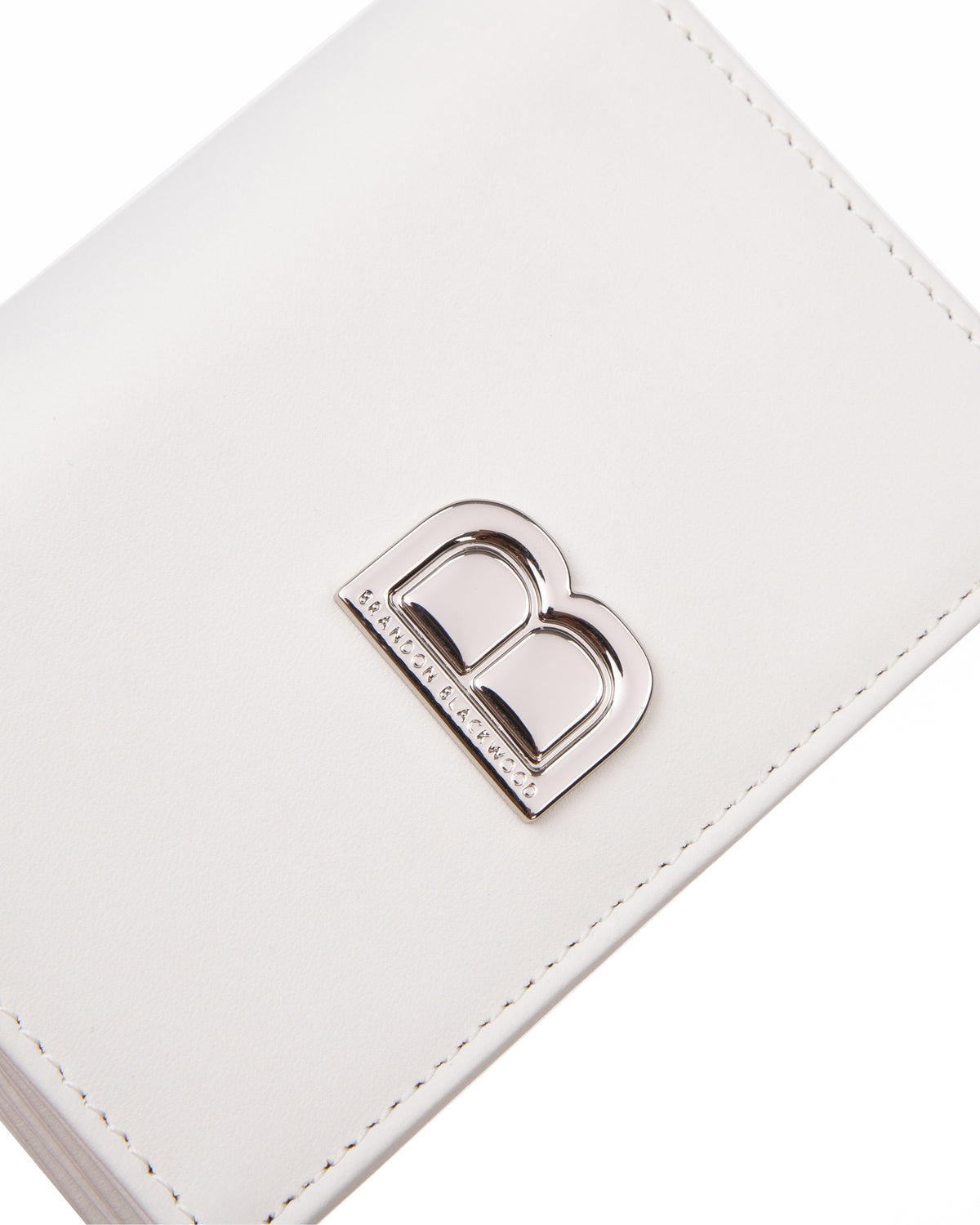 Angled close up of Accordion Card case, white leather body, silver Brandon Blackwood buckle