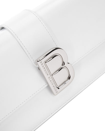 Angled close up of Nia Bag with white hard leather with silver logo magnetic closure  thumbnail 3