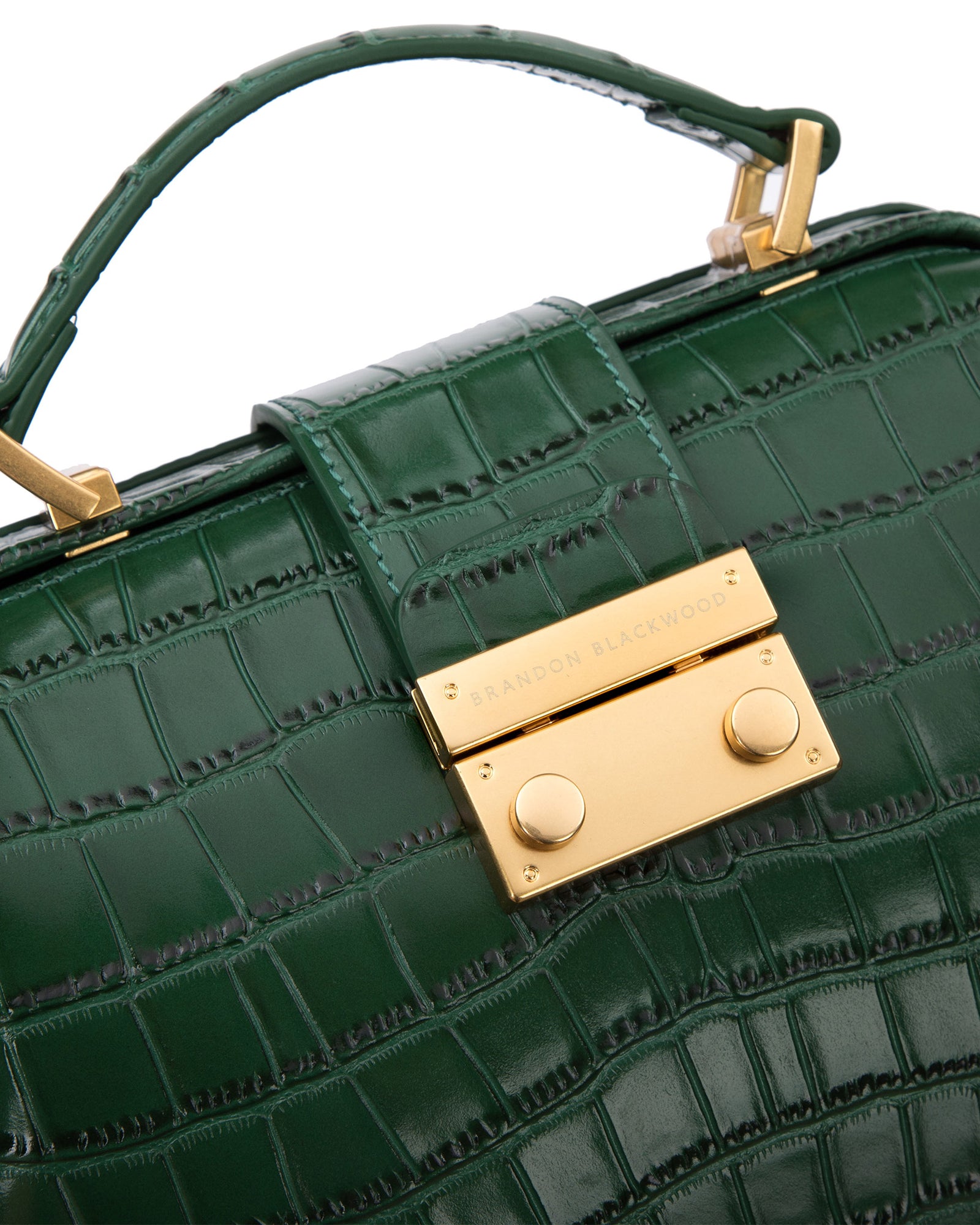 Angled close up of Elizabeth Doctor Bag in hunter green croc embossed leather with brass clasp buckle with embossed logo