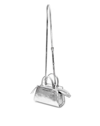 Front of Arlen Bag, metallic silver leather body with leather handle, exaggerated zipper detail Arlen Bag, metallic silver leather body with leather handle, Brandon Blackwood hardware logo, exaggerated zipper detail, hanging from cross body strap thumbnail 6