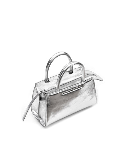 Angled close up of Arlen Bag, metallic silver leather body with leather handle, Brandon Blackwood hardware logo thumbnail 3