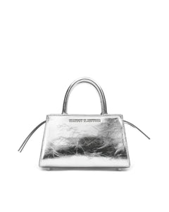 Front of Arlen Bag, metallic silver leather body with leather handle, Brandon Blackwood hardware logo, exaggerated zipper detail 