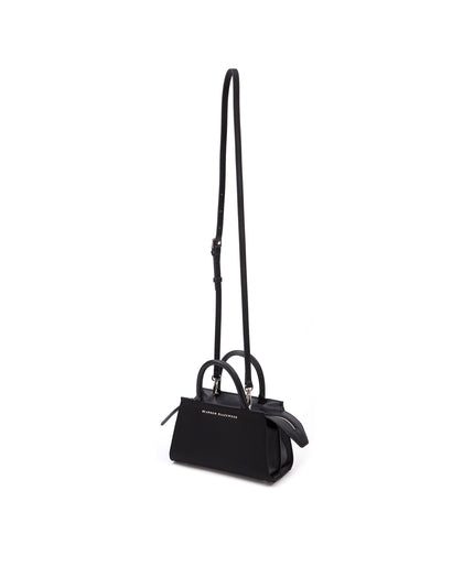 Front of Arlen Bag, black nylon body with leather handle, exaggerated zipper detail Arlen Bag, black nylon body with leather handle, Brandon Blackwood hardware logo, exaggerated zipper detail, hanging from cross body strap thumbnail 4