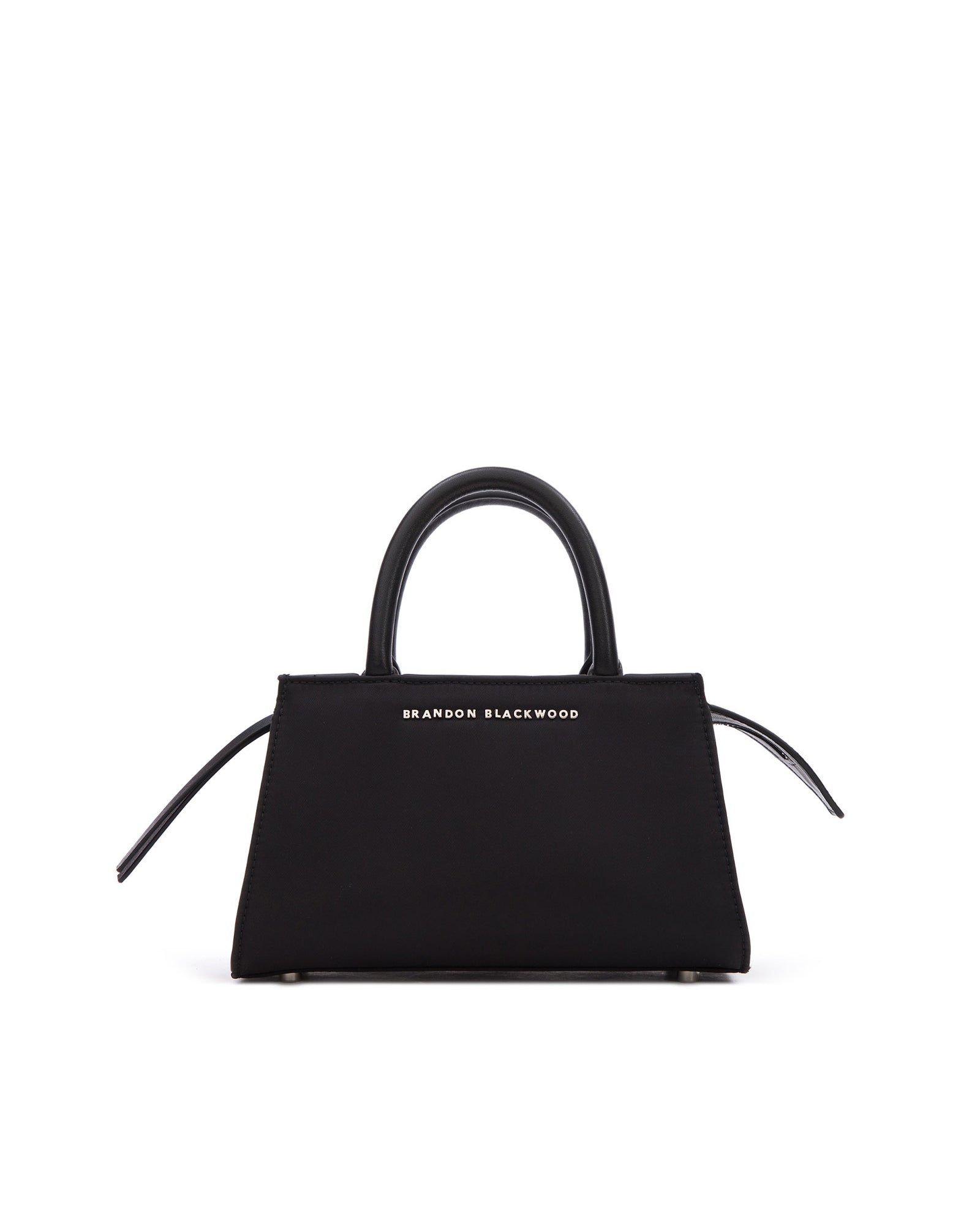 Front of Arlen Bag, black nylon body with leather handle, Brandon Blackwood hardware logo, exaggerated zipper detail 