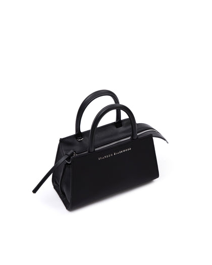 Angled close up of Arlen Bag, black nylon body with leather handle, Brandon Blackwood hardware logo thumbnail 2