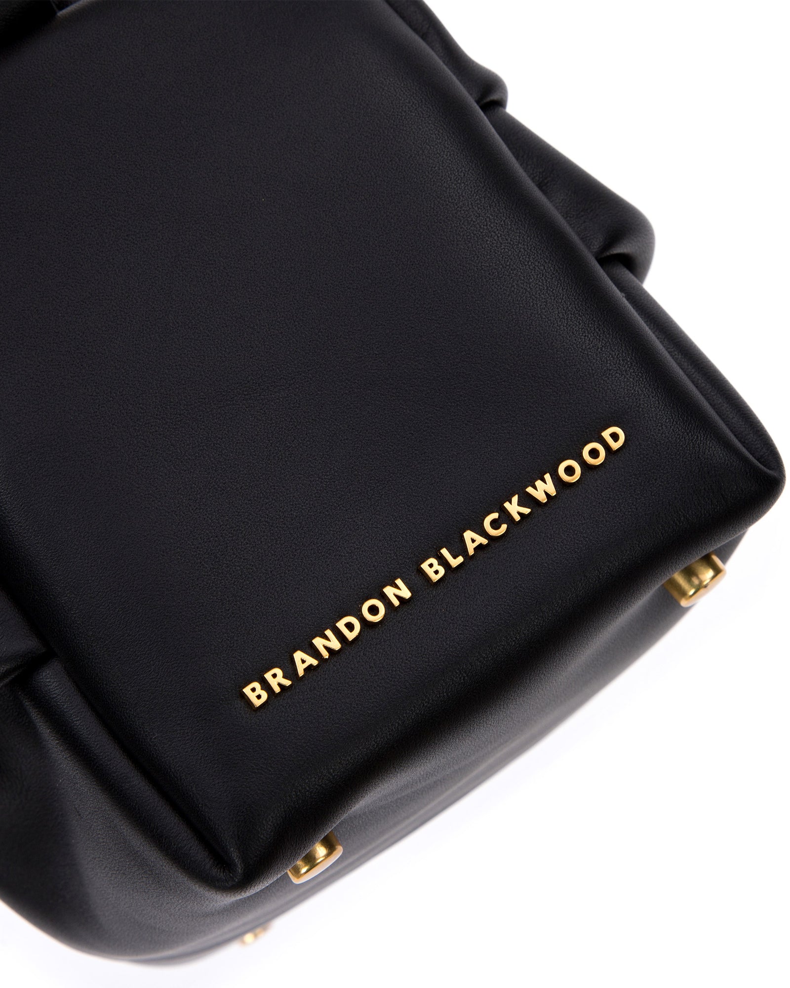 Angled close up of Valentina Shoulder Bag in Black Smooth Leather with Brass Chain Handle