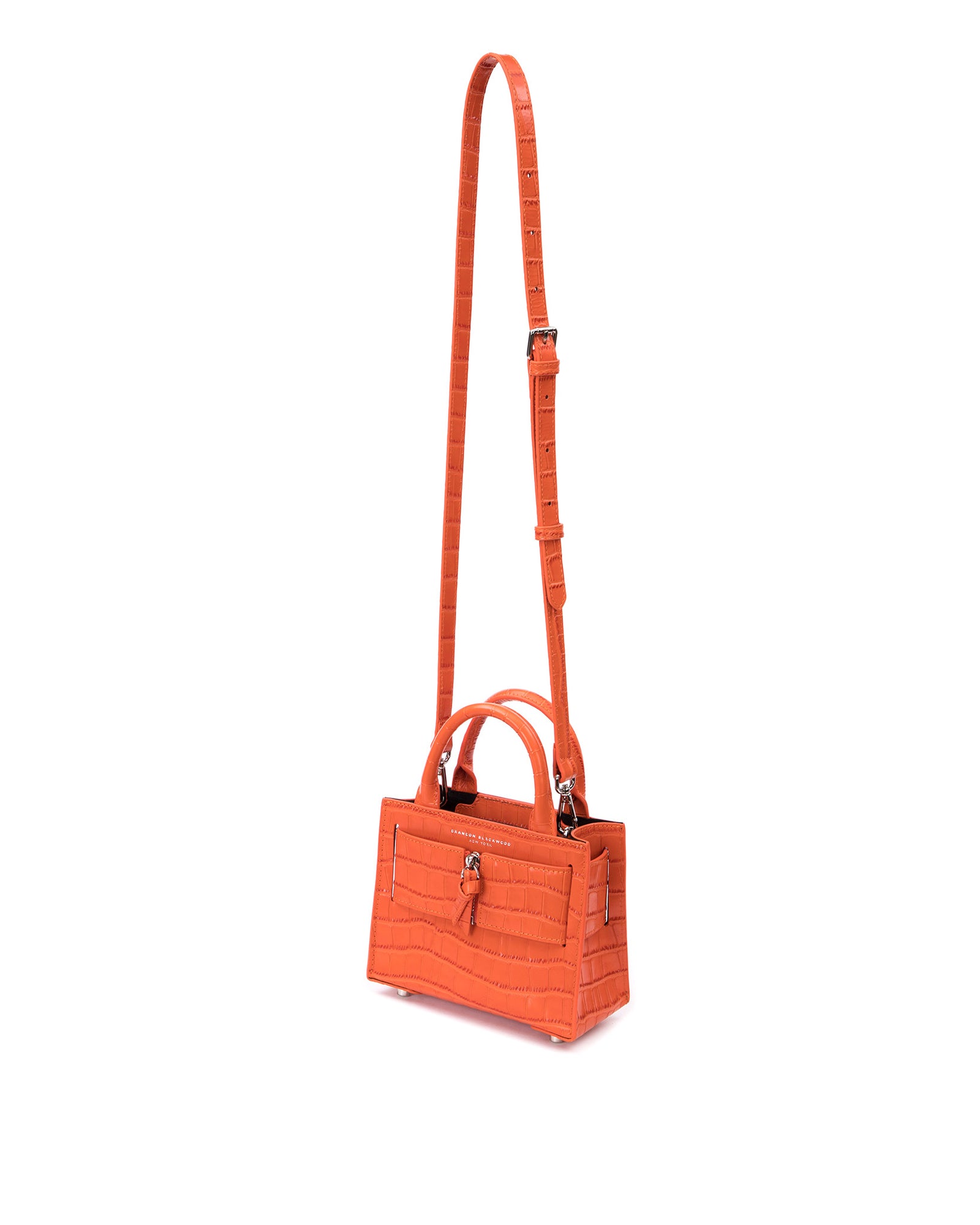 Angled over head view of wide open Kuei Bag in orange croc embossed leather with orange croc embossed handle orange croc embossed silver zipper hanging from strap