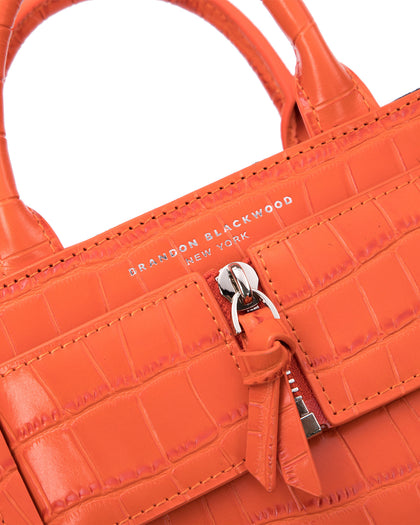 Angled close up of Kuei Bag in orange croc embossed leather thumbnail 3