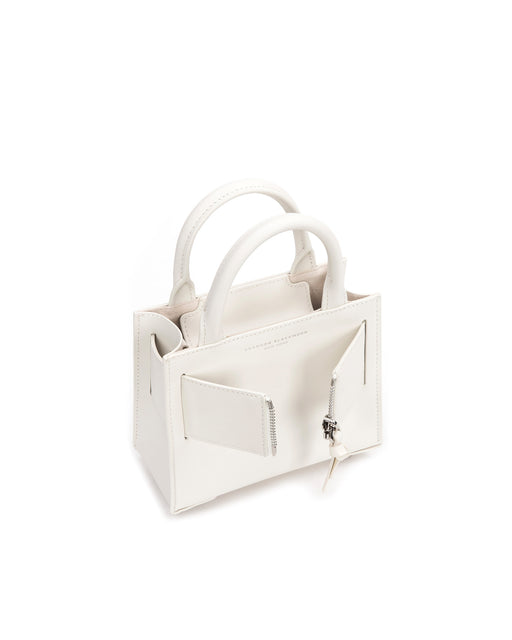 Angled over head view of wide open Kuei Bag in white smooth leather with silver handle leather and silver zipper 