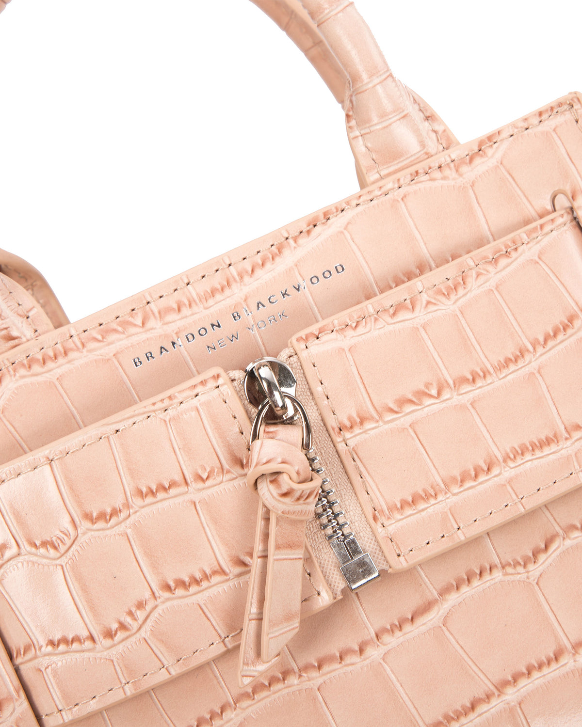 Angled close up of Kuei Bag in cream croc embossed leather