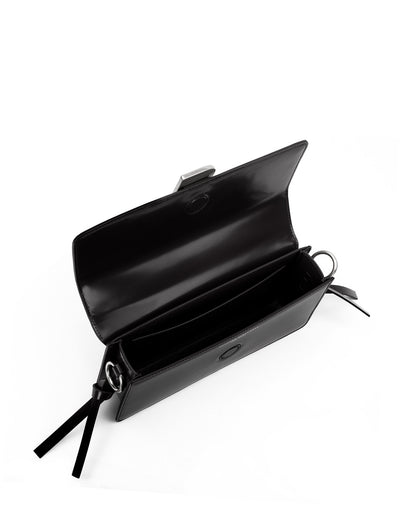 Angled over head view of wide open Nia Bag with black leather and black leather strap with silver  logo magnetic closure thumbnail 2