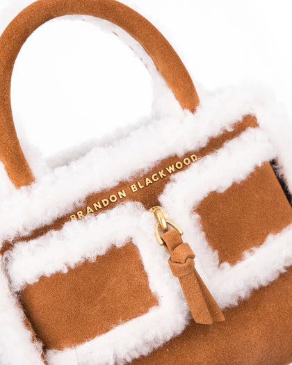 Angled close up of Kuei Bag in tan suede with shearling edges  thumbnail 3
