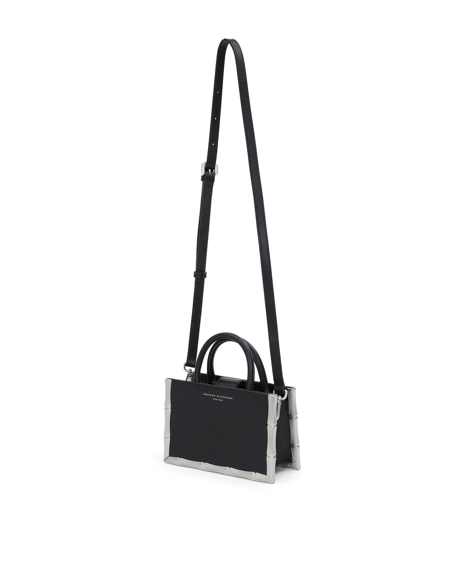 Bamboo B Tote, in black leather with leather handle and silver bamboo embossed trim, hanging from cross body strap