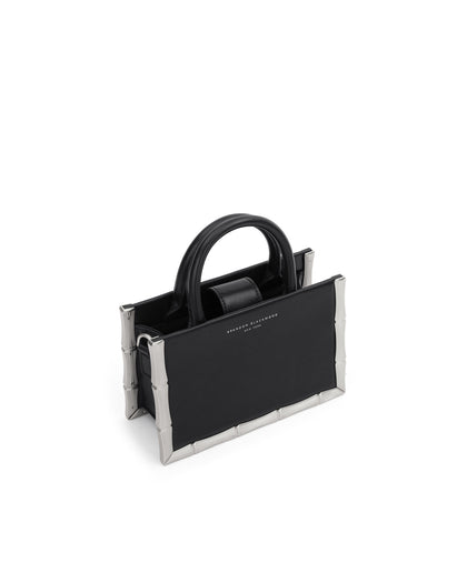 Angled close up Bamboo B Tote in black leather with leather handle and silver bamboo embossed trim thumbnail 4