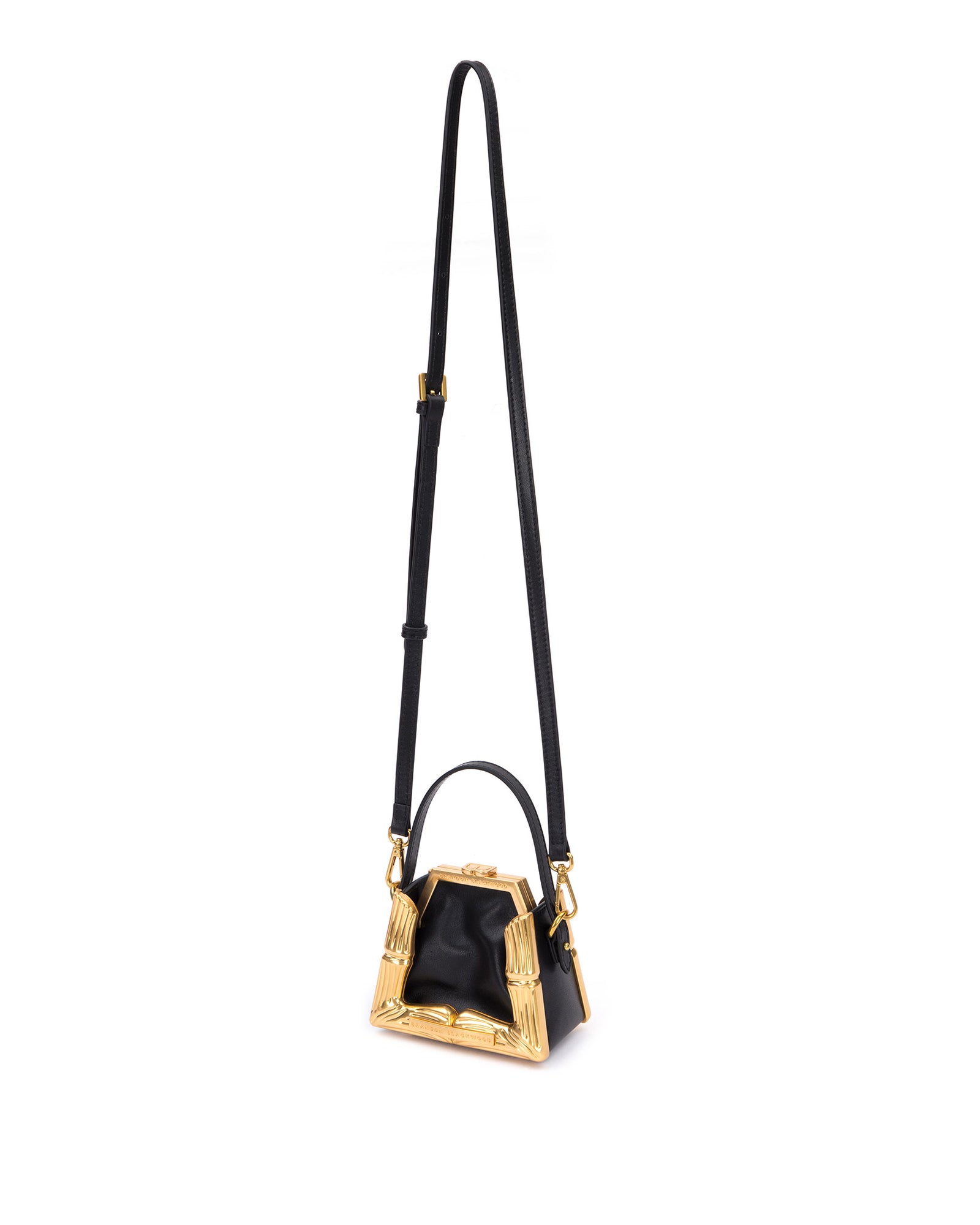 Bamboo B Micro Tote,  in black leather with leather handle and brass bamboo embossed trim, hanging from cross body strap