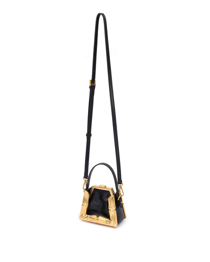 Bamboo B Micro Tote,  in black leather with leather handle and brass bamboo embossed trim, hanging from cross body strap thumbnail 7