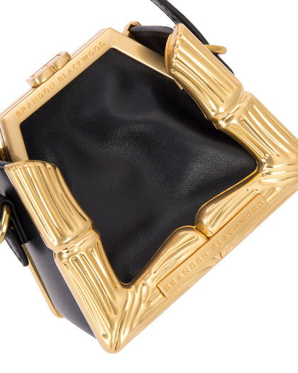 Angled close up Bamboo B Micro Tote in black leather with leather handle and brass bamboo embossed trim thumbnail 3